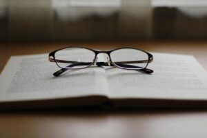 A pair of glasses resting ontop of a book