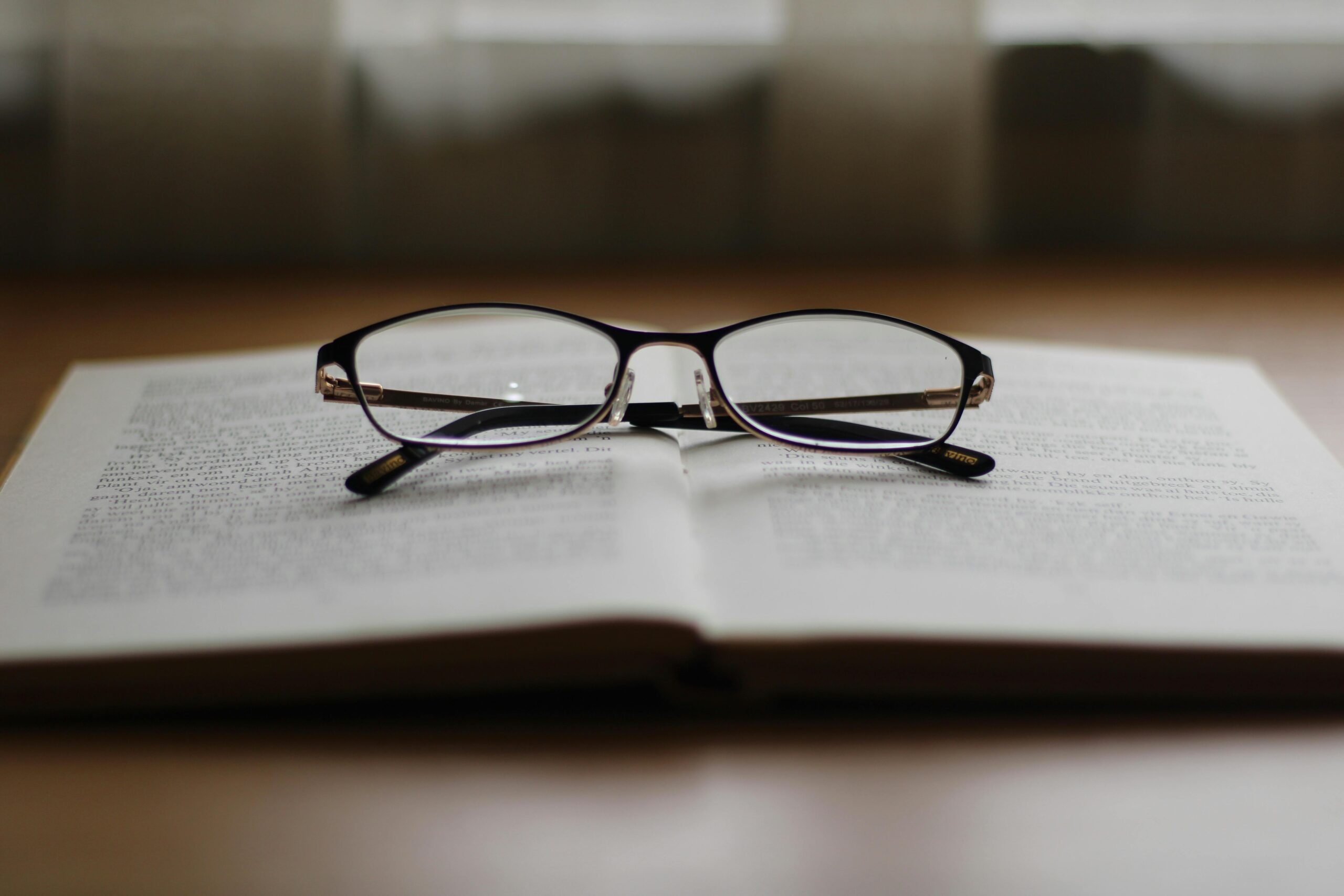 A pair of glasses resting ontop of a book