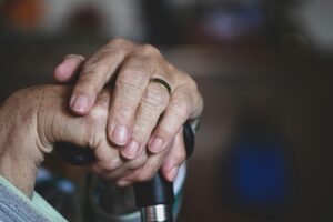 Wrinkled hands using cane