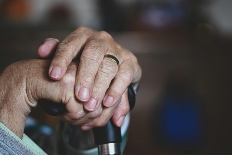 Wrinkled hands using cane