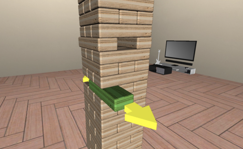 The Jenga tower is on the screen. One of the blocks in the middle is being taken out.