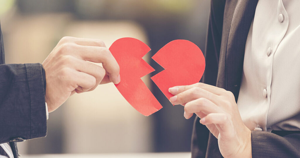 peaceful breakups represented by two people holding a broken heart